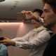 A Korean Air flight attendant holds a Taser gun as other passengers look on and the unruly passenger is subdued (Facebook)